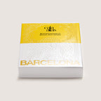 Angle view of the Cala Atlas Barcelona Story Deck box in yellow and white, showing the embossed pattern and Barcelona title