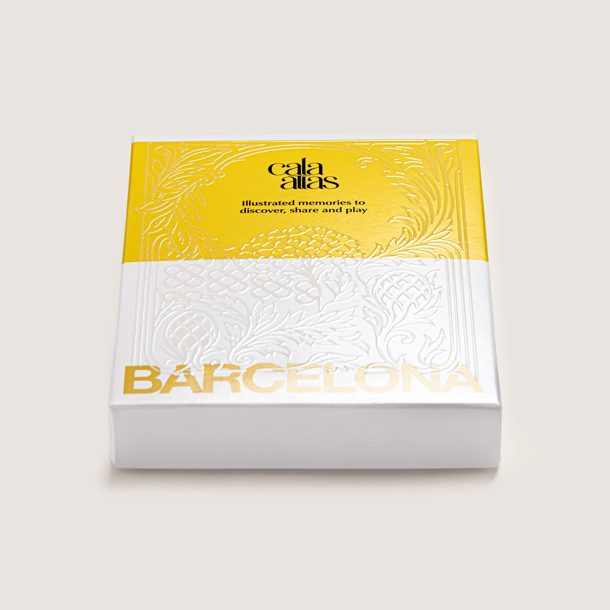 Angle view of the Cala Atlas Barcelona Story Deck box in yellow and white, showing the embossed pattern and Barcelona title