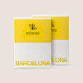 Front view of two Cala Atlas Barcelona Story Deck boxes in yellow and white, showing the embossed pattern and the Barcelona title