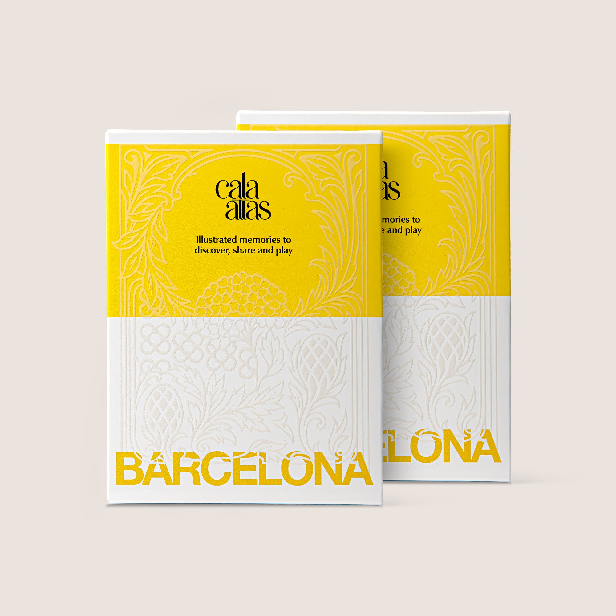 Front view of two Cala Atlas Barcelona Story Deck boxes in yellow and white, showing the embossed pattern and the Barcelona title