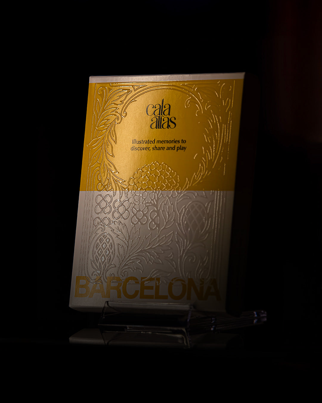 Cala Atlas Story Deck box with embossed yellow and white cover displayed on shelf, dark background